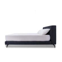 Load image into Gallery viewer, The Emery bedframe features a cushioned headboard, the flat surface can serve as a shelf for small items like phones, glasses and more. Additionally, the platform structure facilitates simple sheet-changing without having to lift the mattress - a feature your back is sure to appreciate. Choice of fabric available.