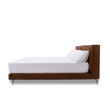 Load image into Gallery viewer, The Emery bedframe features a cushioned headboard, the flat surface can serve as a shelf for small items like phones, glasses and more. Additionally, the platform structure facilitates simple sheet-changing without having to lift the mattress - a feature your back is sure to appreciate. Choice of leather available.
