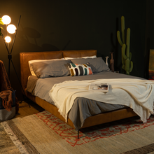 Load image into Gallery viewer, The Emery bedframe features a cushioned headboard, the flat surface can serve as a shelf for small items like phones, glasses and more. Additionally, the platform structure facilitates simple sheet-changing without having to lift the mattress - a feature your back is sure to appreciate. Choice of leather available.