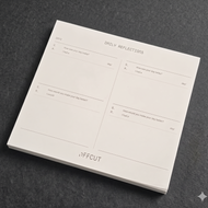 Notebook with daily reflections page on a dark gray background
