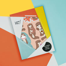 Load image into Gallery viewer, Packaging of reusable fabric decals with cartoon dog designs on a colorful geometric background
