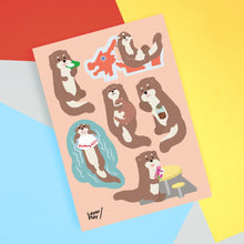 Load image into Gallery viewer, Sheet of cartoon otter stickers on a colorful background
